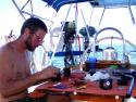 Jim doing maintenance on the watermaker in the cockpit