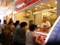 People lined up to purchase fresh beef from the butcher